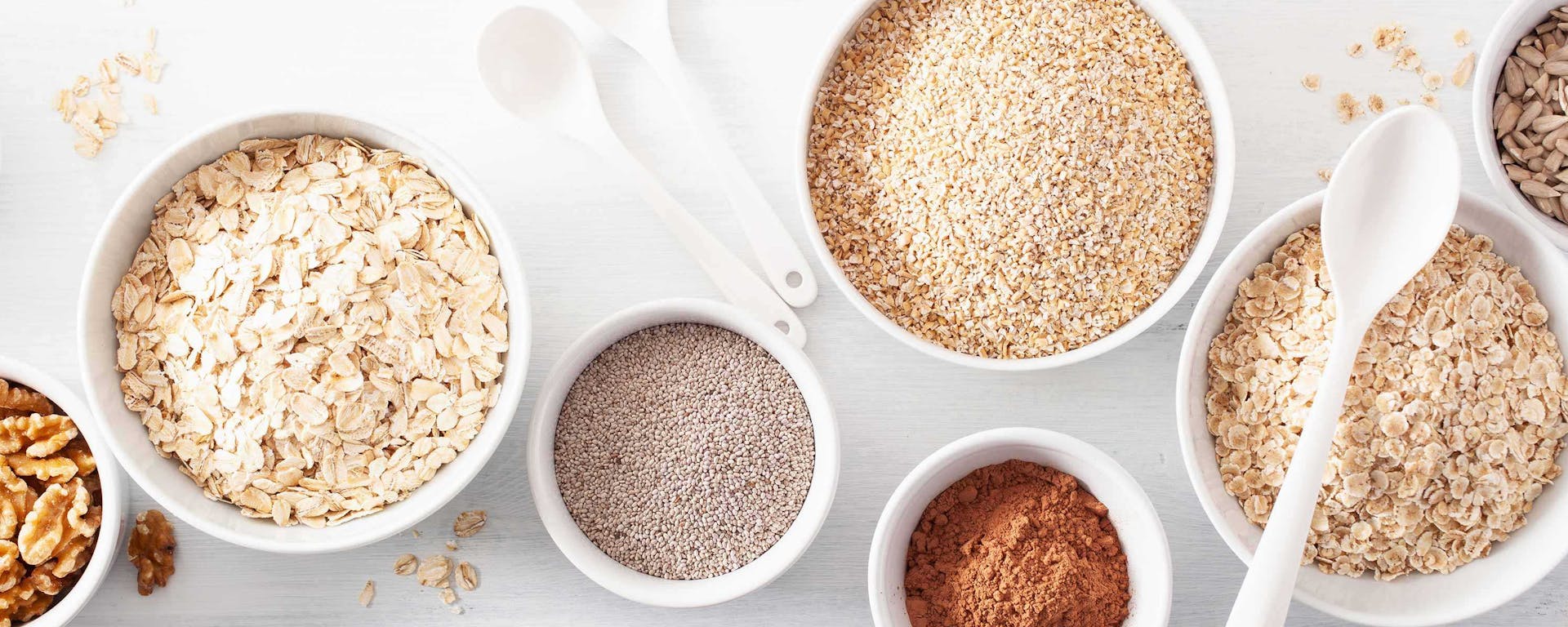 A number of bowls that are filled with miscellaneous grains.