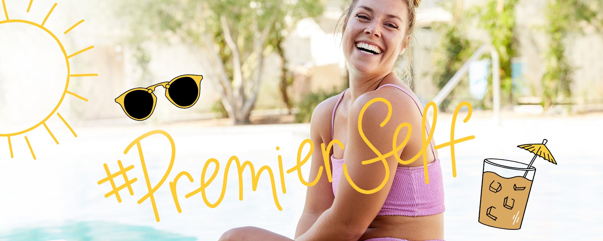 A woman sitting and laughing outside by the pool. On top of the photo, the Premier Self hashtag is handwritten and surrounded by illustrations of sunglasses and a festive protein shake.