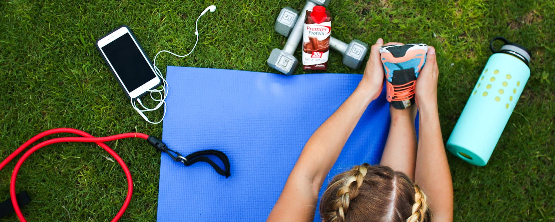 A person exercising with Premier Protein near.