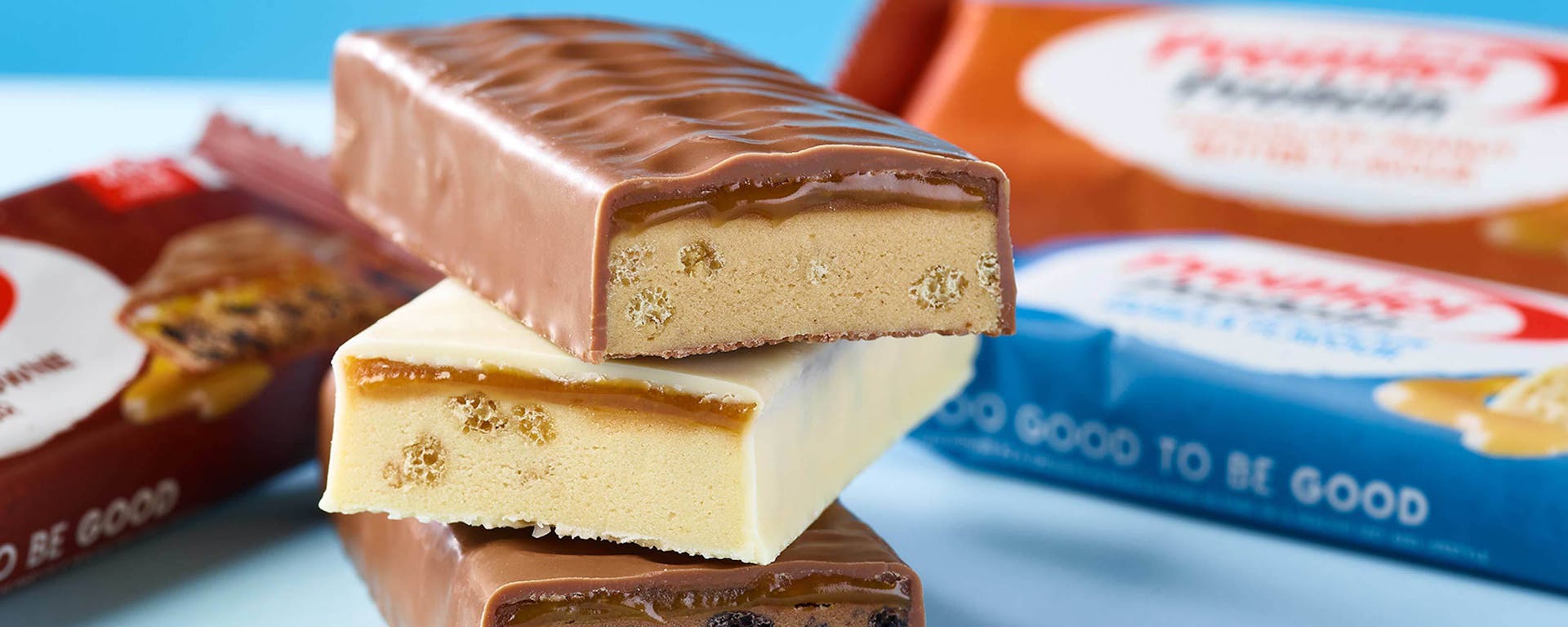 A pile of 3 Premier Protein Bars stacked on top of each other.